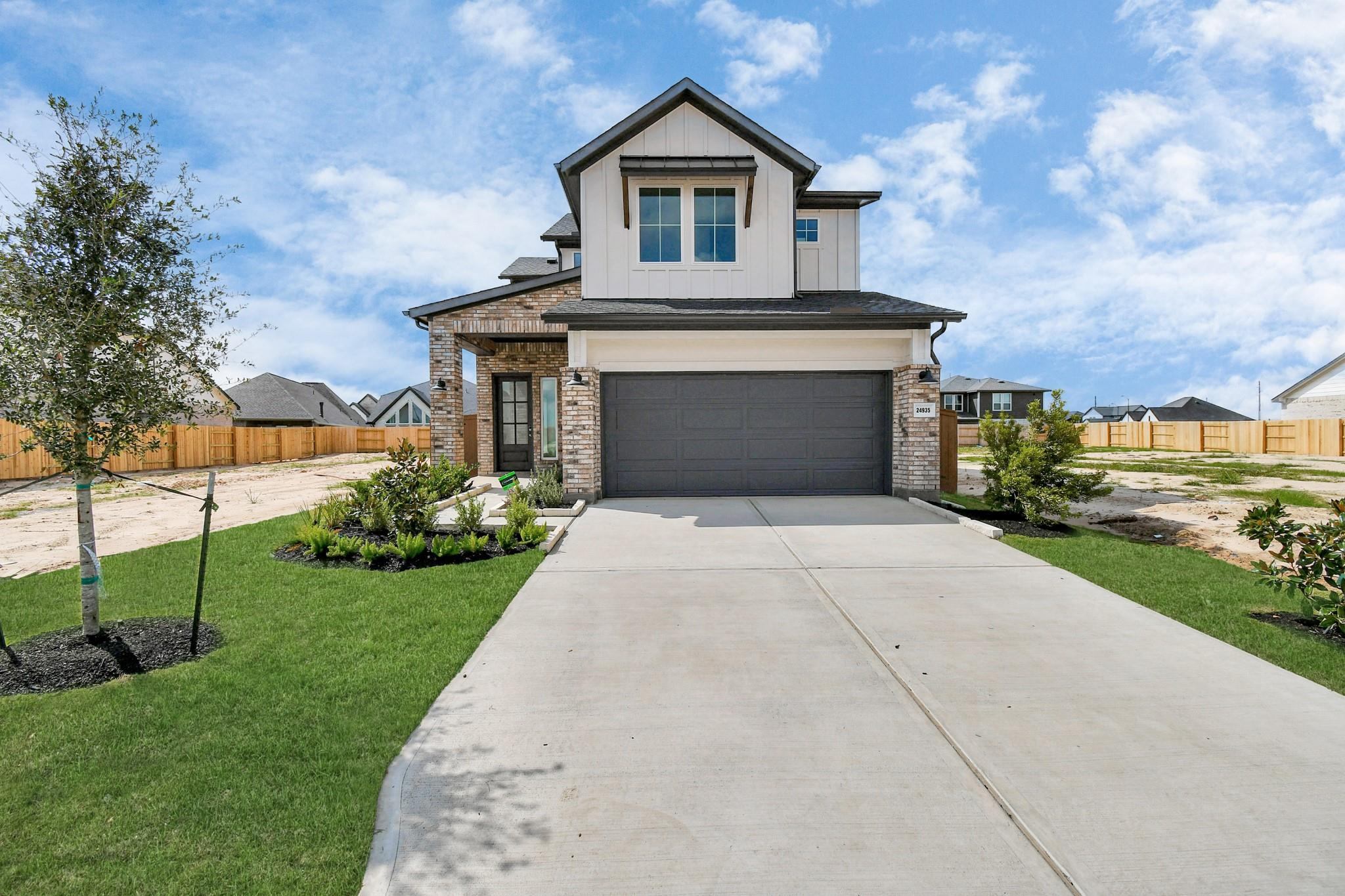 New construction two-story home with board and batten siding in Houston